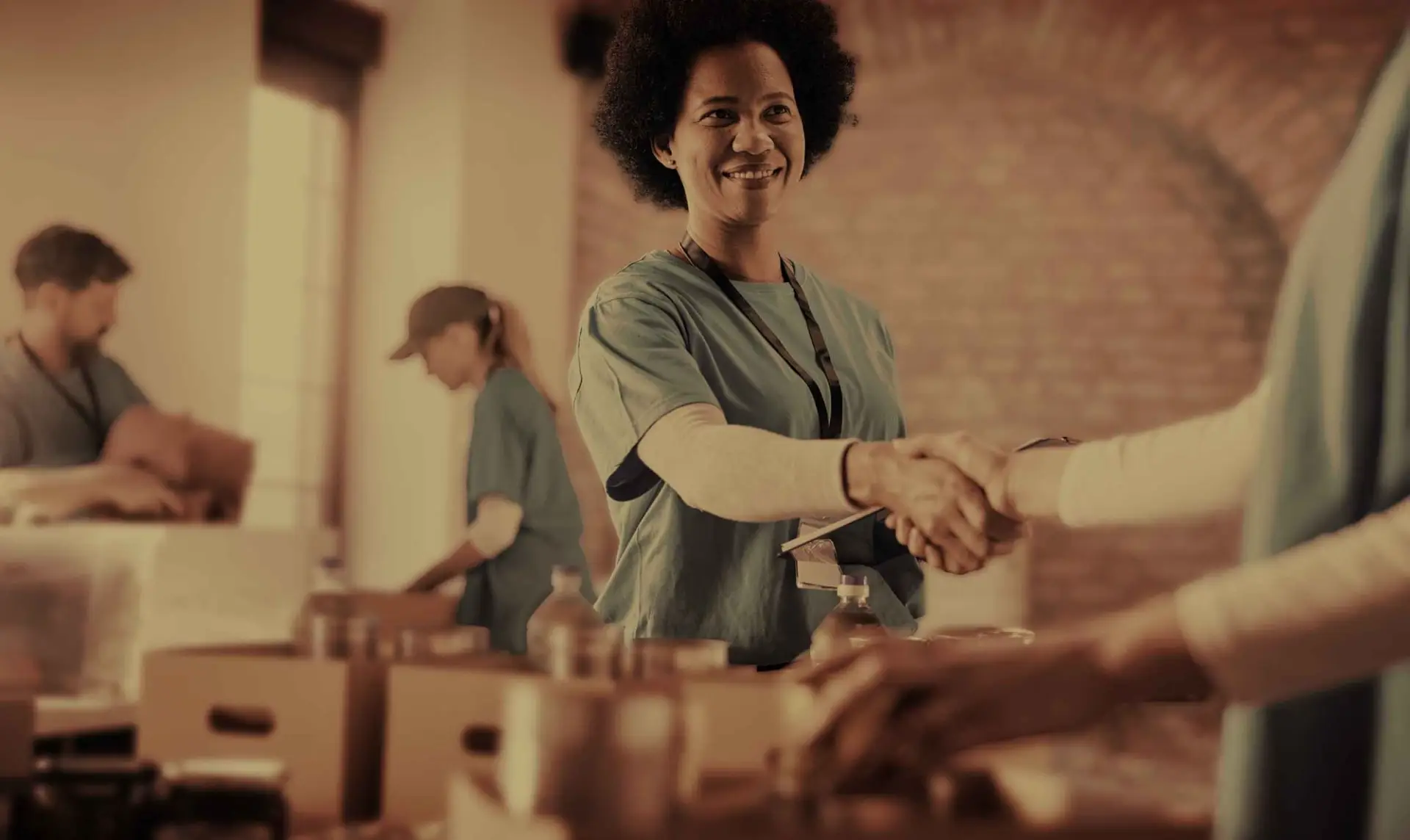 A volunteer shaking hands with a partner