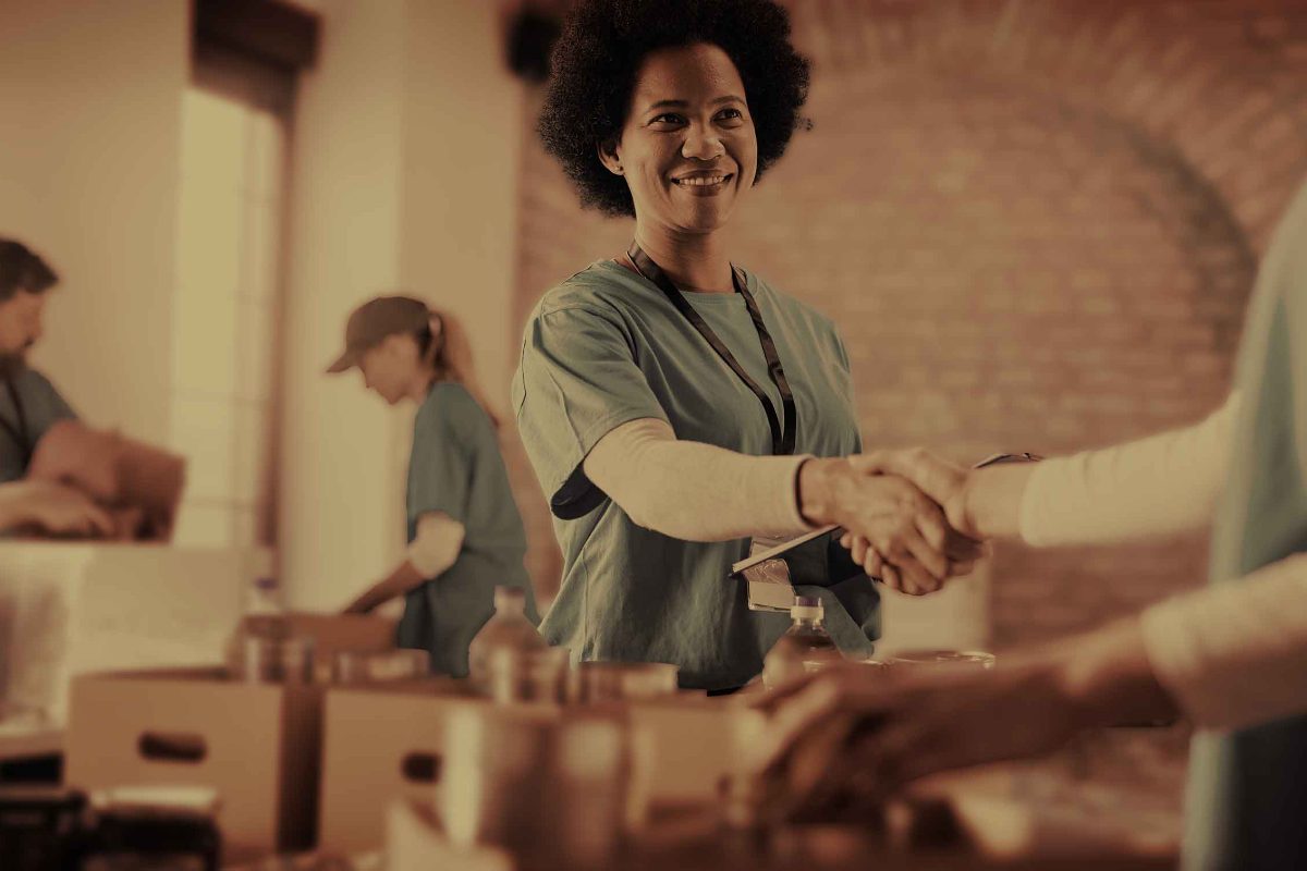 Volunteers welcoming people at a Capital Cares distribution
